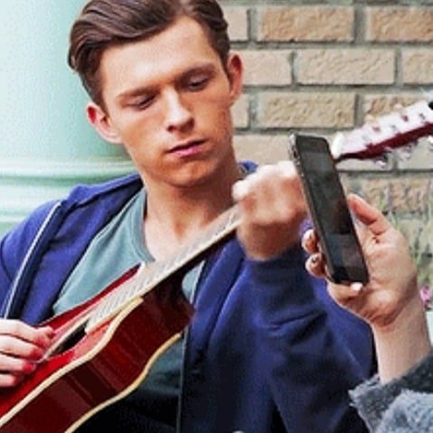 tom holland playing guitar