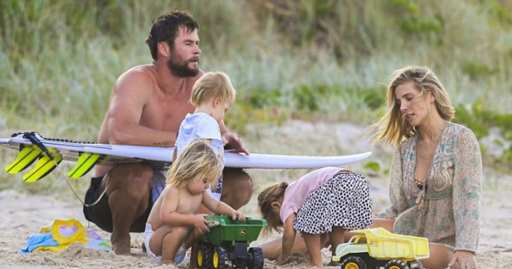 Chris Hermsworth with his family on a beach 