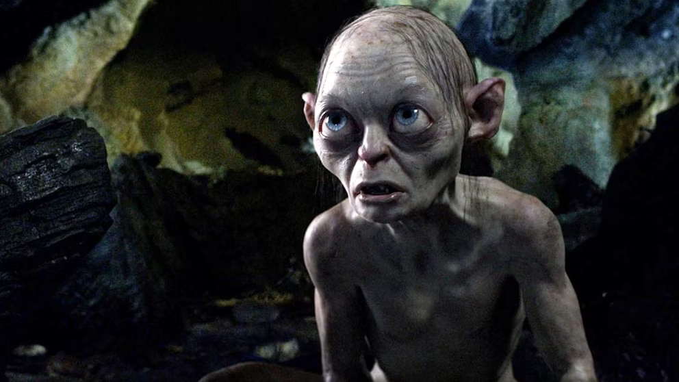 Gray-skinned, large-eyed creature crouching in a dark cave with a startled expression.